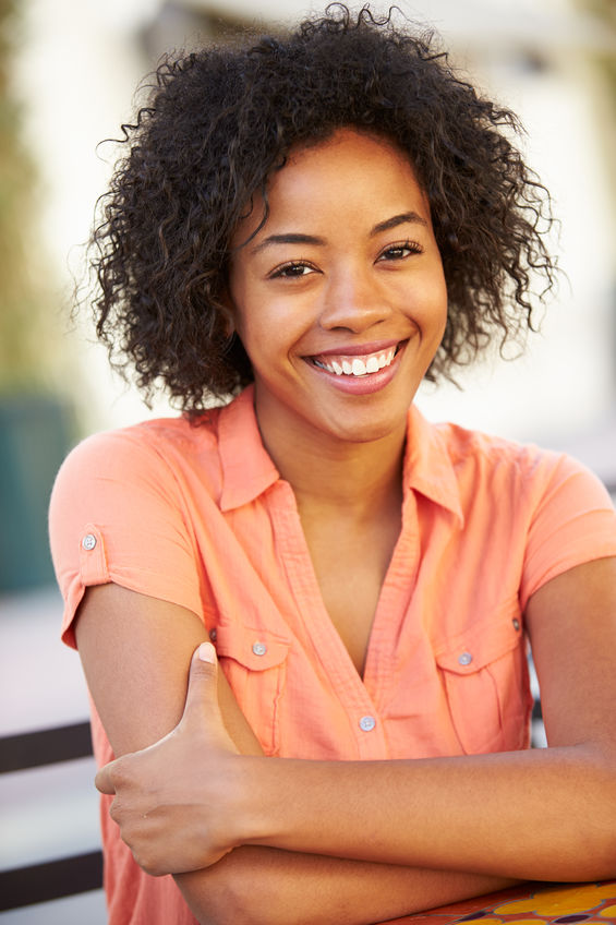 Smiling young woman who has used undecylenic acid to end her fungal infections.