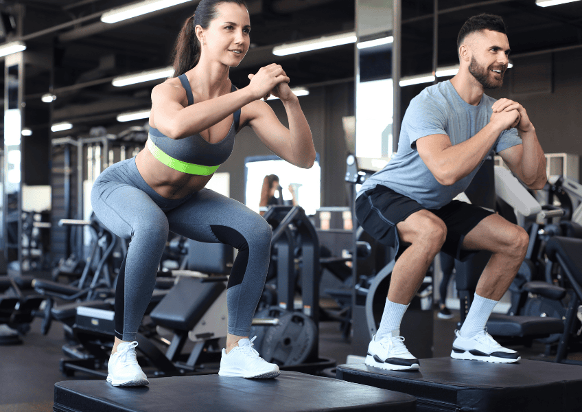 Man and woman working out in the gym.